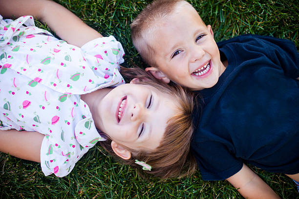 istock Cute Young Children Smiling on Grass 579228546