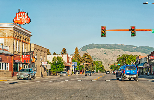 Cody, Wyoming, USA - July 19, 2016: This is Cody Wyoming and this main street view show many of the shops and restaurants along this highway road that  ultimately passes right through the community, Cody is not one of the smaller towns in Wyoming, Cody was named after Buffalo Bill and his partisapation in the development of the area. The Shoshone River runs through the town. On this July day after spending  a night  in Cody and enjoying dinner at one of the restaurants it  was an interesting city to check out.