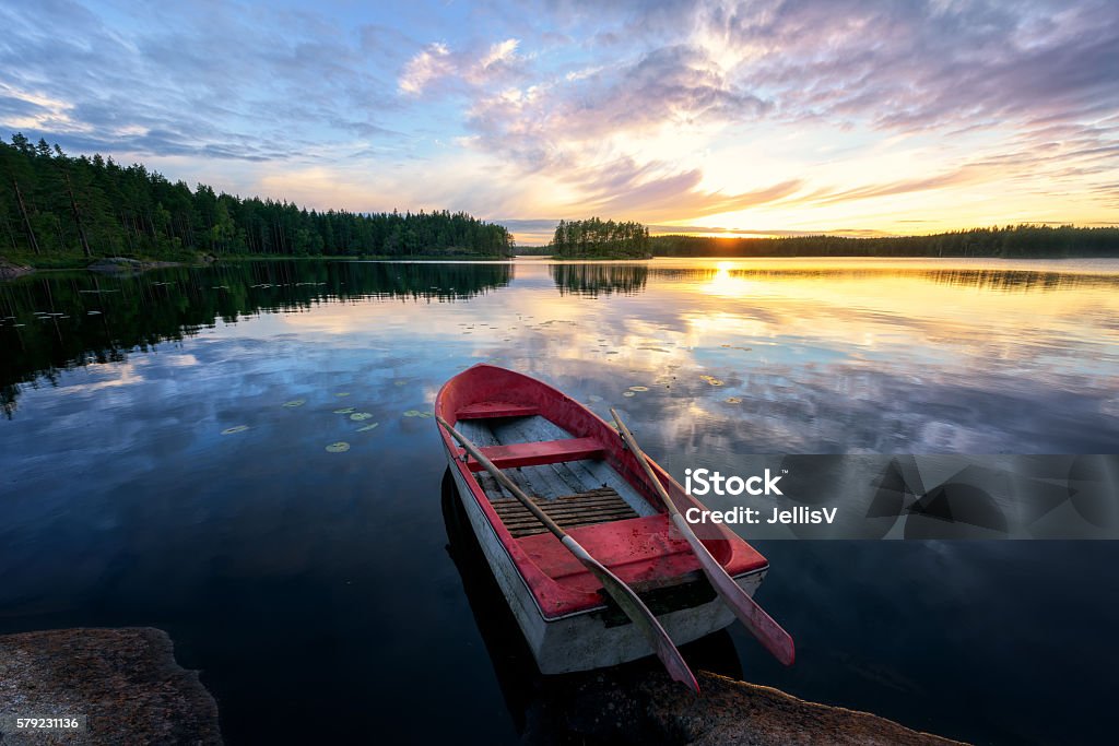 Rowboat With Stunning Sunset Rowboat with stunning sunset. Lake Stock Photo