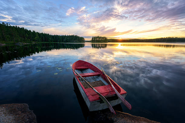 rowboat with stunning sunset - wood tranquil scene serene people lake imagens e fotografias de stock