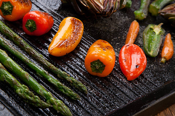 Grilled Vegetables Assorted grilled vegetables - zucchini, asparagus, artichokes, mini pepper, jalapeno, tomatoes, and carrots - on griddle. griddle stock pictures, royalty-free photos & images