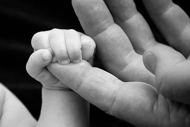 istock Baby holding dad's hand 579231594