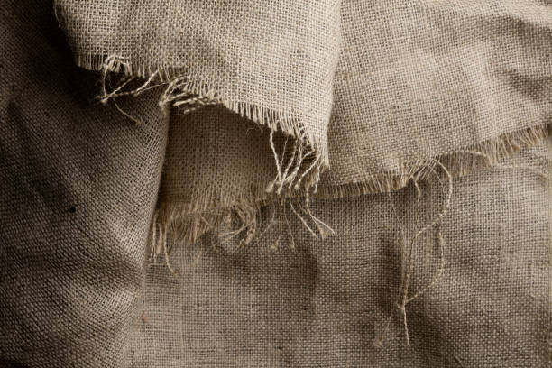 Rustic Burlap Background A burlap sheet with frayed edges. Frayed stock pictures, royalty-free photos & images