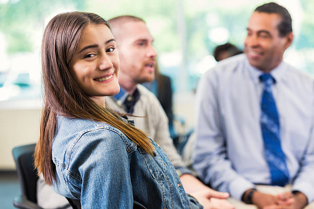 istock Smiling young woman at meeting 579232538