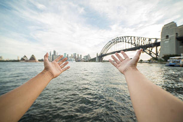 istock Person's arms stretch towards Sydney skyline, Australia 579234294