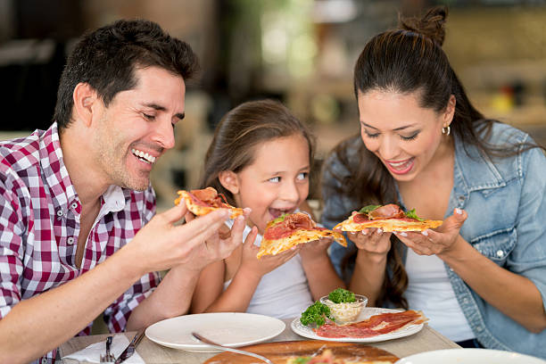 istock Family eating pizza at a restaurant 579235854