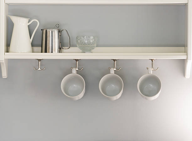 istock coffee cups hanging in a row with jug and glass 579237164