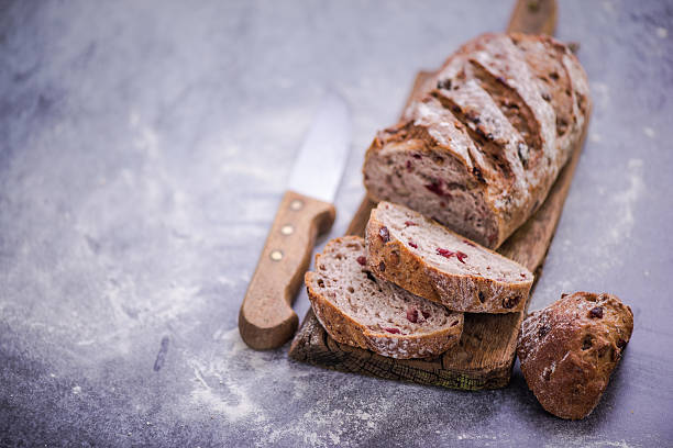 istock cutting slice of bread from loaf 579237170