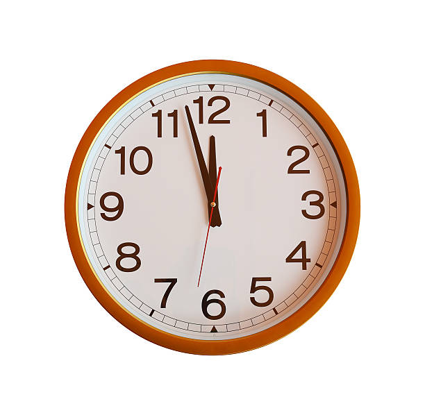istock orange wall clock isolated in twelve o'clock. 579237870