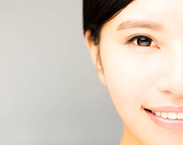 istock half face of young beautiful woman 579238000
