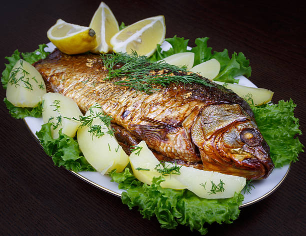 istock Carp cooked in the oven with potatoes and lemon 579242596