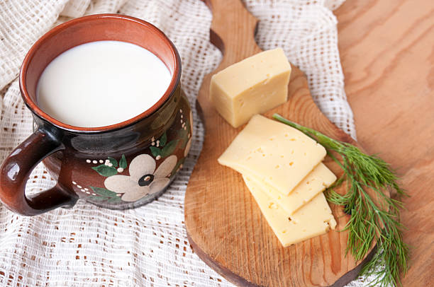 pitcher of milk and cheese with chopped dill - кувшин imagens e fotografias de stock