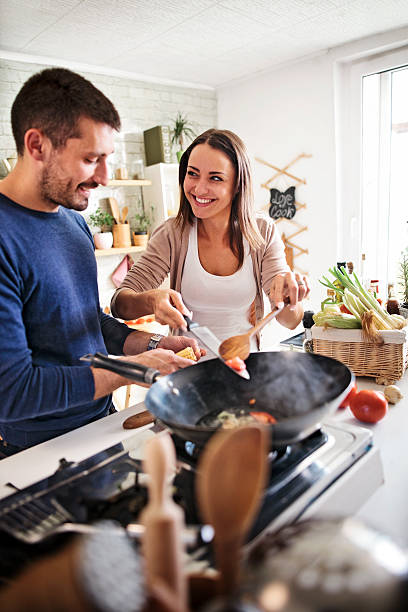 istock young couple cooking together 579244548