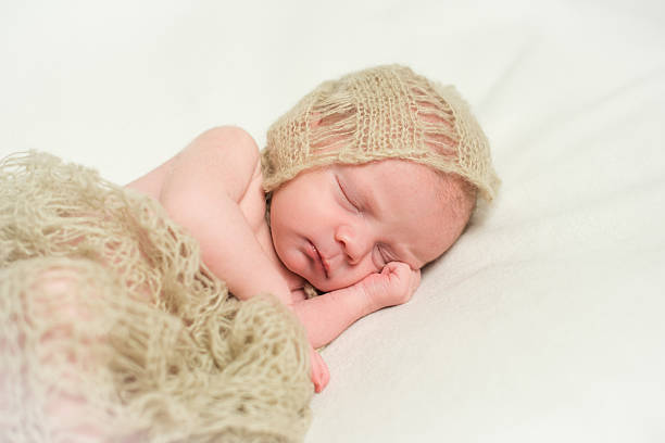 istock Newborn baby sleeping with hand under his cheek. Close-up 579245912