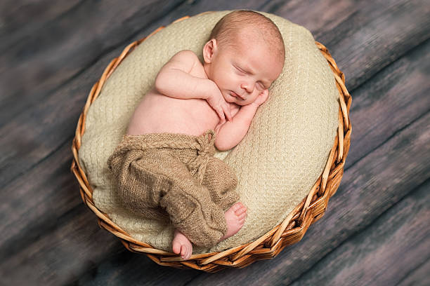 istock Newborn baby sleeping in a round basket 579246046