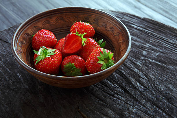 istock Red fresh strawberries on black rustic wood background 579246460