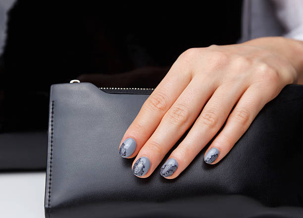 Close-up of painted nails and a wallet stock photo