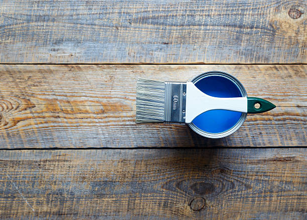istock jar with blue paint on the wooden background top view 579248480