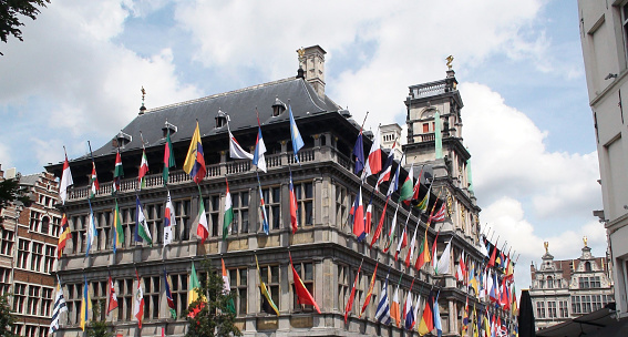 Antwerp Town Hall Building With Lots Of Flags In Belgium Europe