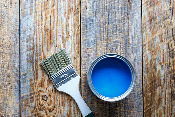 istock open paint jar and brush on wooden background top view 579248698