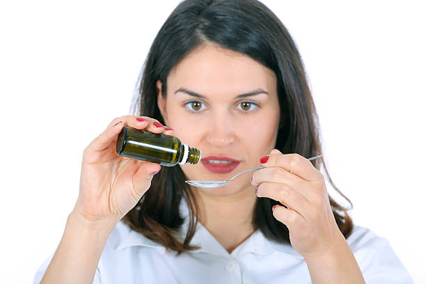 istock woman taking medicine on spoon 579249682