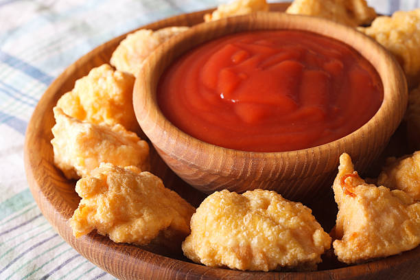 istock crispy popcorn chicken fillet with sauce closeup on a plate 579253196