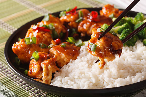 general tso's chicken with rice for dinner. horizontal close-up - chicken general tso food imagens e fotografias de stock