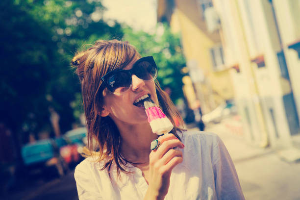 istock Attractive woman eating ice cream. 579254576