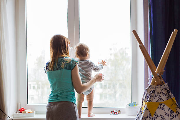 istock Cute baby boy looks in the window 579256004