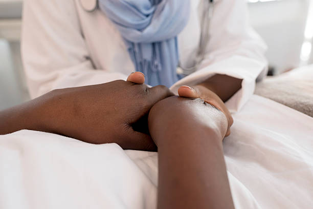 istock Woman Patient Holding Female Doctors Hands 579260070