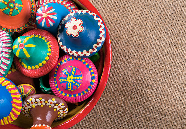 Brightly colored bowls are arranged at a vibrant market stall.