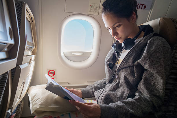istock Woman reading news in plane 579261962