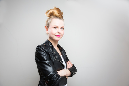 Portrait of a beautiful midadult woman wearing beehive hair with black leather jacket