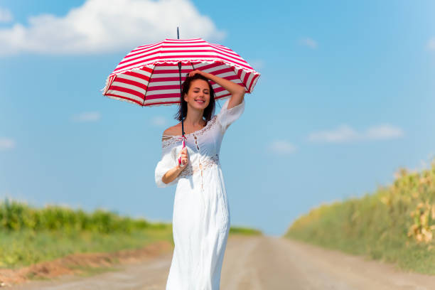 istock young woman with umbrella 579264290