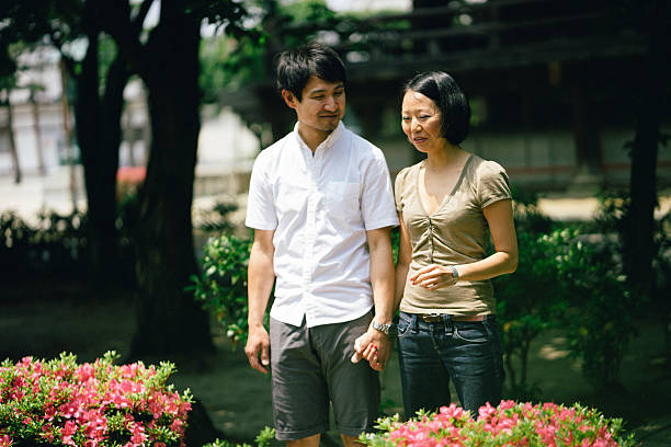 istock Cheerful japanese couple at the temple, front view 579264828