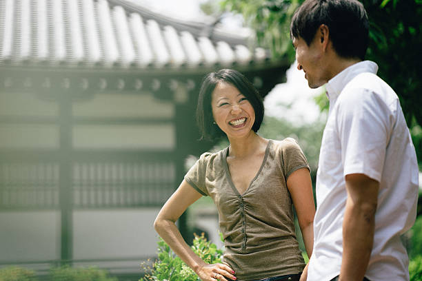 istock Cheerful japanese couple at the temple, front view 579265470