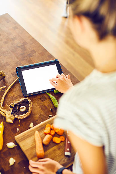 istock Over the shoulder view of woman touching digital tablet 579265520