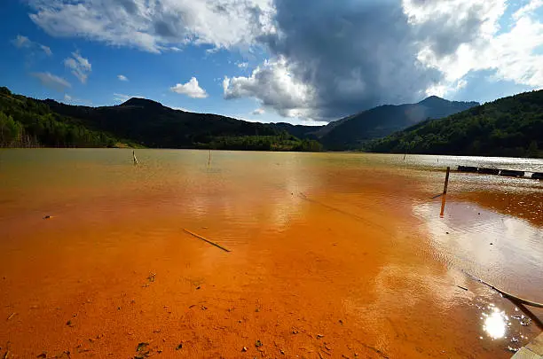 red polluted lake in Romania, Alba, Geamana