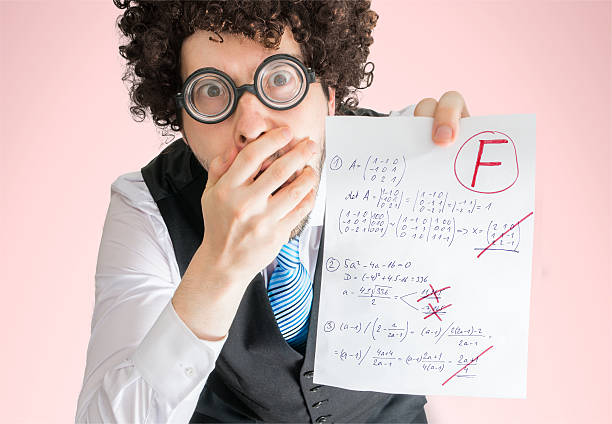 istock Unsuccessful student is showing math exam with bad results. 579400178