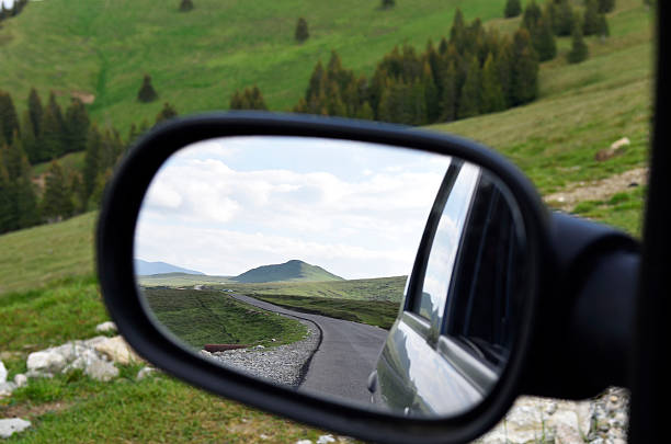 istock Lonely road seen through rear mirror 579400612