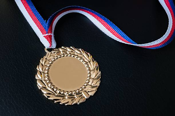 istock Golden medal for first place on black background. 579401312