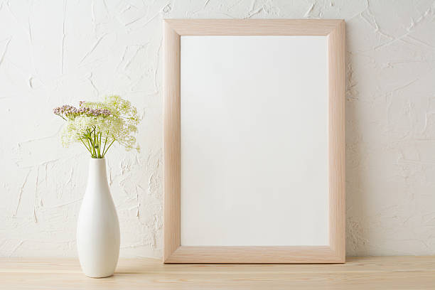 istock Frame mockup with tender flowers in white stylish vase 579402212