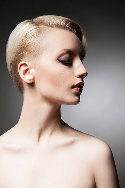 istock Beautiful young model with make-up and hairstyle looking down 579403042
