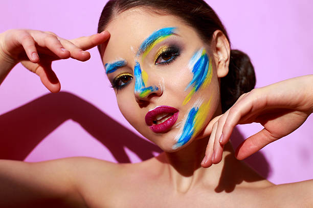 istock beautiful girl with paint on her face 579404302