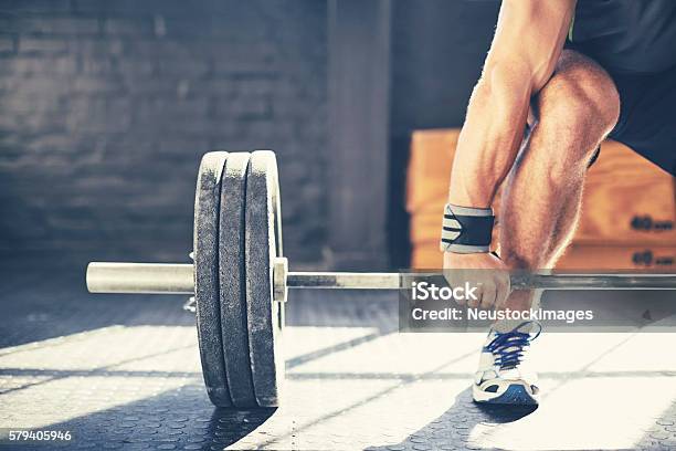 Cropped Image Of Muscular Man Deadlifting Barbell In Gym Stock Photo - Download Image Now