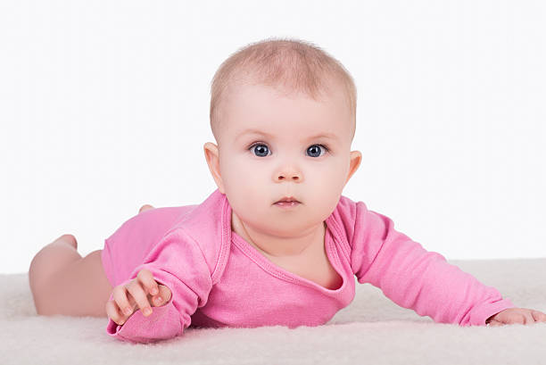 istock baby girl lying on blanket and try crawling 579407218