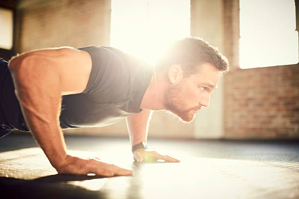 istock Side view of determined man doing push-ups in gym gym 579408518