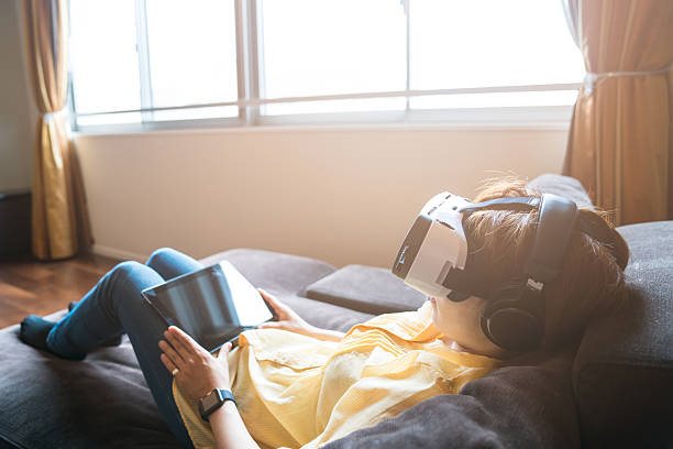 istock Young woman trying out a virtual reality headset 579408640