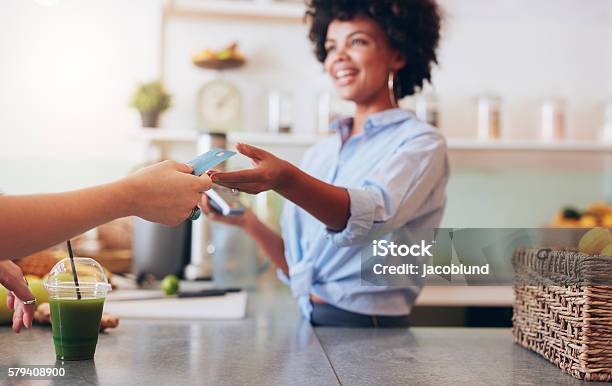 Female Employee Taking Payment From Customer Stock Photo - Download Image Now - Paying, Credit Card, Playing Card
