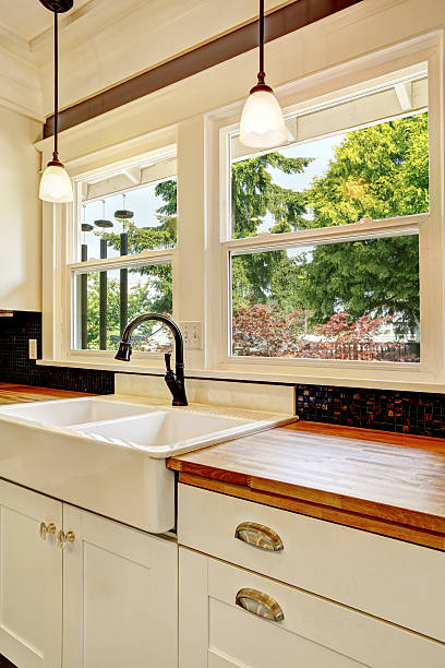 istock Kitchen interior in white tones with hardwood counter top. 579408944